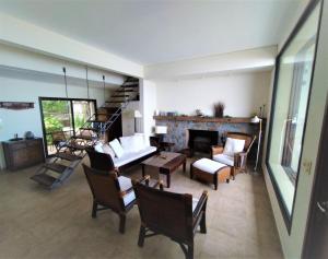 a living room with a couch and a fireplace at Casa espectacular directo sobre el mar in Las Flores