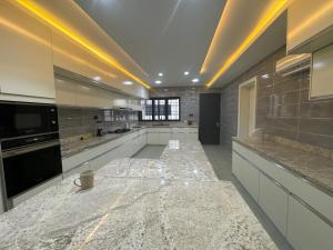 a large kitchen with a large marble counter top at Luxury Villa within Abuja Sanctuary in Abuja