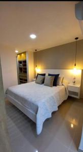 a bedroom with a large white bed with pillows at Se alquila apartamento in Cali