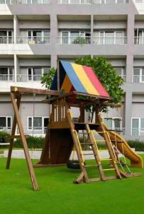 a playground with a slide in front of a building at LD Cozy 1BR Grace Residences, Taguig near BGC in Manila