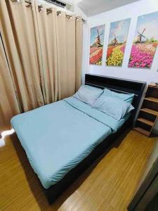 En eller flere senge i et værelse på LD Cozy 1BR Grace Residences, Taguig near BGC