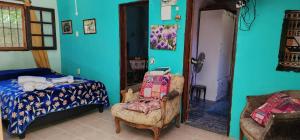 a bedroom with a bed and a chair and a bed at Casa en Ciudad de la Costa ideal para descanso in Ciudad de la Costa