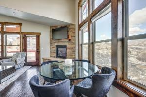 a dining room with a glass table and chairs at All-Season Heber City Condo with Stunning Views! in Heber City