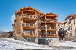 a large apartment building with snow in front of it at All-Season Heber City Condo with Stunning Views! in Heber City