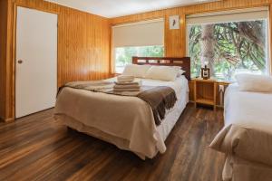En eller flere senge i et værelse på Hostal Viento Sur