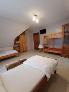 a bedroom with two bunk beds and a staircase at Willa Gorce in Ostrowsko