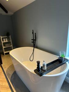 a white tub with a keyboard on top of it at Luxury Home in Blackpool in Blackpool