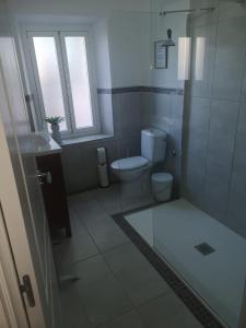 a white bathroom with a toilet and a shower at Vegan garden Apartment in Cuevas del Almanzora +2 photos