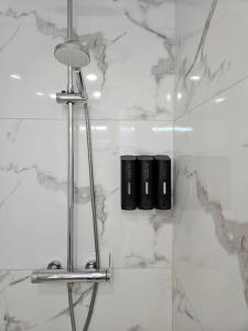 a bathroom with a shower with two black candles at Loft independiente de Lujo. in Valencia
