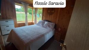 a bedroom with a bed and a window at CASA DE CAMPO in Villarrica