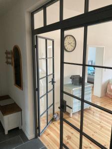 an open door with a clock on a wall at SUITE-DREAMS APARTMENT - Innenstadt in Hannover