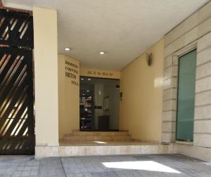 an entrance to a building with a door and stairs at Eurolan 93 in Bogotá