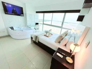 a large bathroom with a large bed and a tub at Ecusuites Ejecutiva Mini view río guayas Aeropuerto in Guayaquil +37 photos