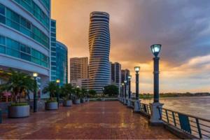 a city with tall buildings and a street light at Ecusuites Ejecutiva Mini view río guayas Aeropuerto in Guayaquil