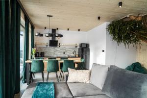 a living room with a couch and a table at TATRZAŃSKIE TARASY Luxury Chalets in Małe Ciche