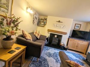 a living room with a couch and a tv at The Casey in Fenny Bentley