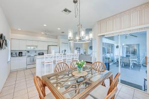 a kitchen and dining room with a table and chairs at Naples Vacation Rental Home with Heated Private Pool in Naples