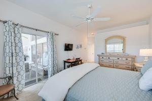 a bedroom with a bed with a ceiling fan at Naples Vacation Rental Home with Heated Private Pool in Naples +26 photos