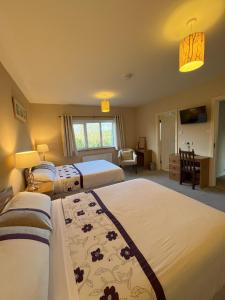 Letto o letti in una camera di PK Lodge Bed and breakfast