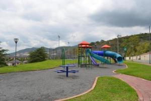 a playground with a slide in a park at Ecusuites Penthouse Vía Costa Ceibos Puerto Azul in Guayaquil
