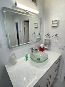 a bathroom with a sink and a mirror at Modern Miami Oversized 3 Bedroom in Central Location in Miami