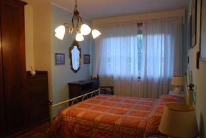 a bedroom with a bed and a dresser and a mirror at Alle porte di Torino, ai piedi del M.te S. Giorgio in Bruino