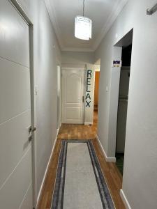 a hallway with a white door and a rug at Kadıköy Holiday Home in Istanbul