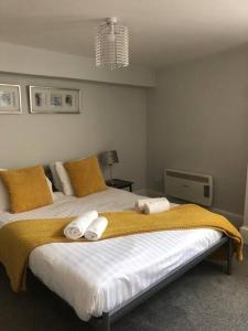 a bedroom with a large bed with two pillows at The Stuart Suite - spacious, affordable, city centre in York