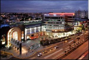 a city at night with cars on a street at Ecusuites Penthouse Torre Sol Aeropuerto Mall Del Sol in Guayaquil