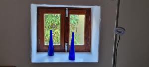 three blue vases sitting on a window sill at Casa Rural Anais in La Aldea de San Nicolas
