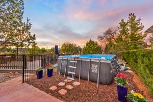 a garden with a hot tub and a ladder at Serene Home- Sleeps 16 - Pet Friendly - Hot Tub - Pool in Sedona