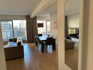 a living room with a table and a couch at 2 Bedroom Apartment in Center with Balcony in Brussels