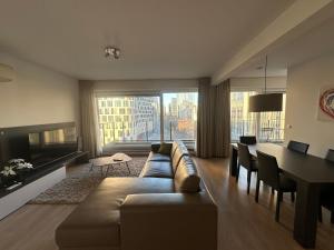 a living room with a couch and a dining room at 2 Bedroom Apartment in Center with Balcony in Brussels