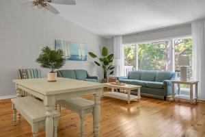 a living room with a table and a couch at Lagoon Villa Condo in Isle of Palms