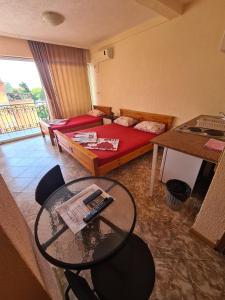 a living room with a bed and a table at Apartments Bulatović in Bar