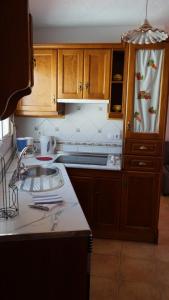 a kitchen with a sink and a counter top at El Rinconcito de Rosa ideal parejas in Nerja +17 photos