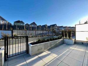 a patio with a fence and some houses at Family Friendly Ground Level Condo in Surrey