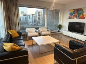 a living room with a couch and a table at Apartment with Stunning View in City Center in Brussels