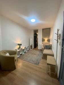 a living room with couches and a cross on the wall at The Bachelor Backpacker Spot in Brussels