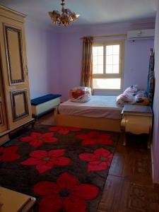 a bedroom with a bed and a window and a rug at شقة فندقية بالإسكندرية بڤيو لا مثيل له in Alexandria