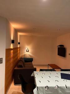 a living room with a bed and a couch at Appartement Terrasse 4 personnes in Les Rousses