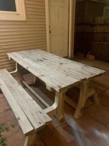 a wooden picnic table and a bench on a patio at Entire 1 Bedroom Top Floor Rental Unit with Patio in Chicago