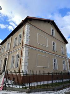a building with a fence in front of it at MH Apartment Rzeszów in Rzeszów