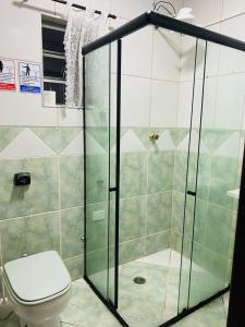 a bathroom with a toilet and a shower at HOSTEL ANPRADO in Guarulhos