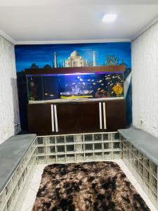 a room with a fish tank on the wall at HOSTEL ANPRADO in Guarulhos