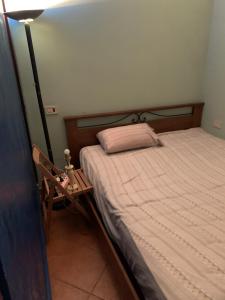 a bedroom with a bed and a night stand next to it at BnB Convalis in Palermo