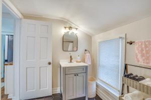 a bathroom with a sink and a mirror at Chic New Hartford Apartment - Hike, Golf and Ski! in New Hartford
