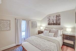 a white bedroom with a bed and a window at Chic New Hartford Apartment - Hike, Golf and Ski! in New Hartford