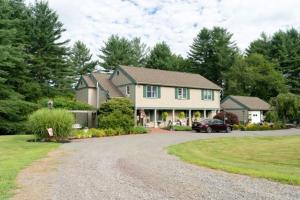 a house with a car parked in the driveway at Paper Mill Pines Bed and Breakfast 