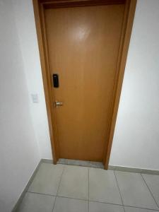 a brown door in a room with a tile floor at ITAPARICA BEACH CLUB in Vila Velha